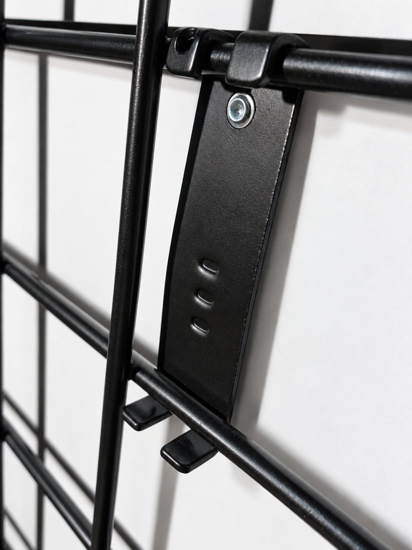 AI-cleaned close-up of the artwork mounting bracket on the grid